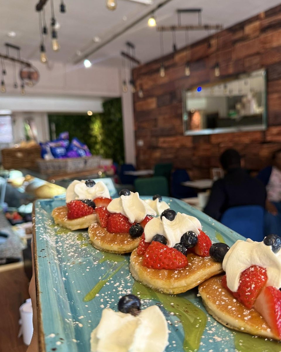 Pancakes with strawberries, blueberries and cream